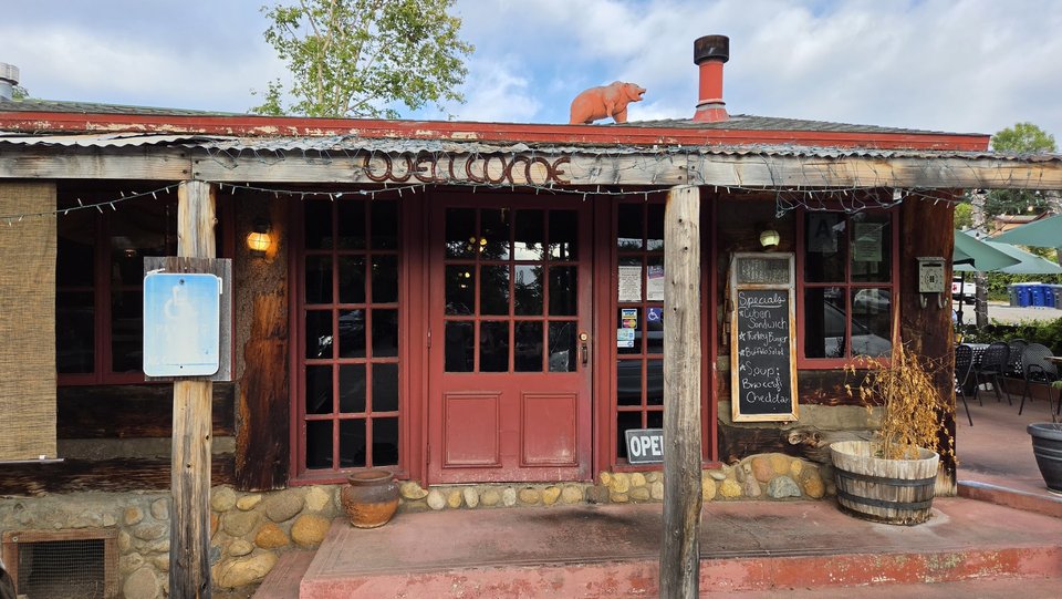Outdoor tables beside a casual bar and grill.