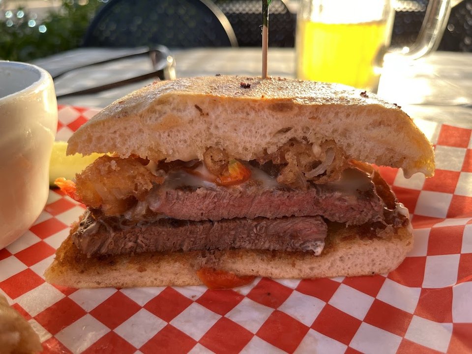 Printed menu showing appetizers and specialty burgers.
