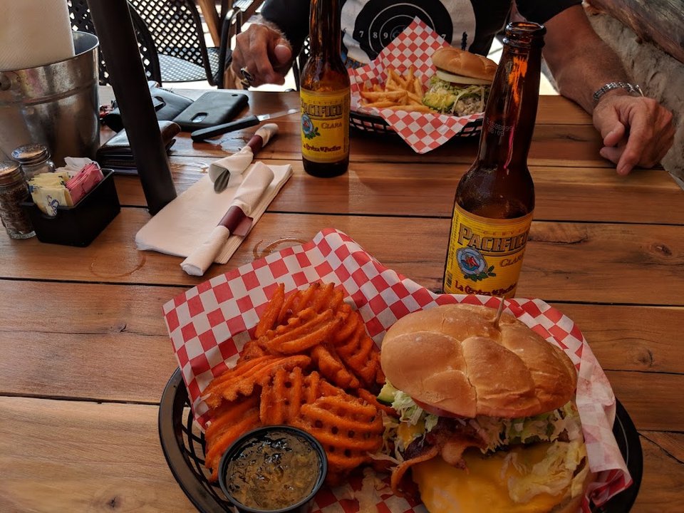 Printed menu showing appetizers and specialty burgers.